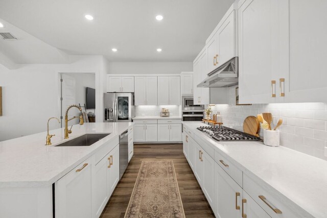 kitchen featuring white cabinets, a sink, stainless steel appliances, under cabinet range hood, and visible vents