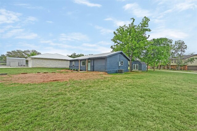 view of yard with an outbuilding and central AC unit