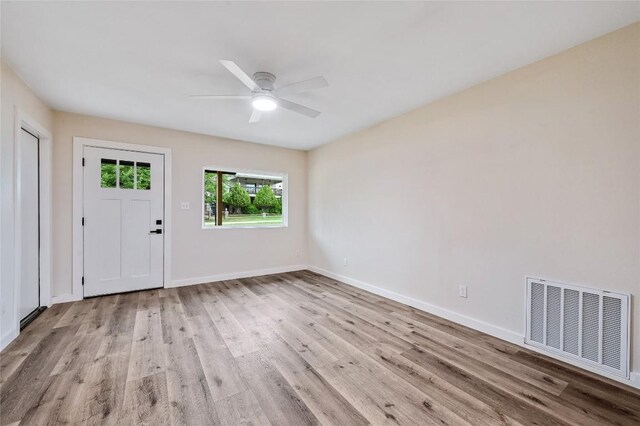 entrance foyer featuring visible vents, a ceiling fan, baseboards, and wood finished floors