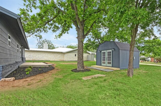 view of yard with french doors and an outdoor structure