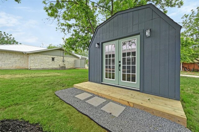 view of outdoor structure with french doors and an outdoor structure