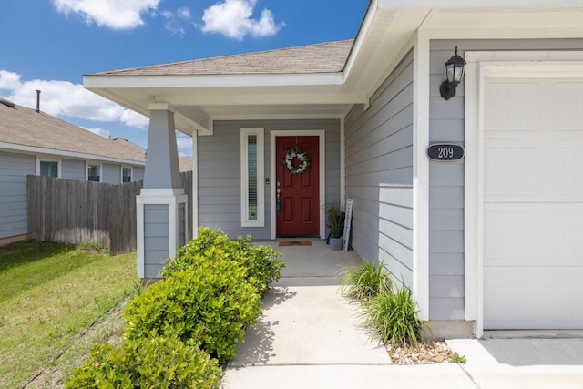 doorway to property with fence and a porch
