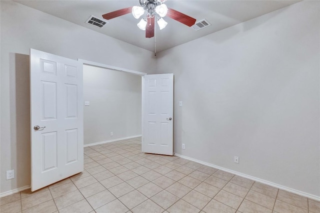 unfurnished room featuring visible vents, baseboards, ceiling fan, and light tile patterned flooring