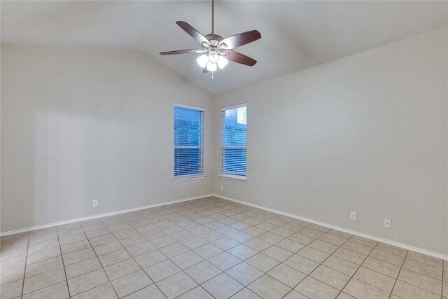 empty room featuring baseboards, ceiling fan, and lofted ceiling