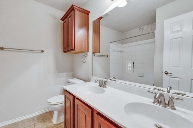 bathroom with a shower, a sink, tile patterned floors, and toilet