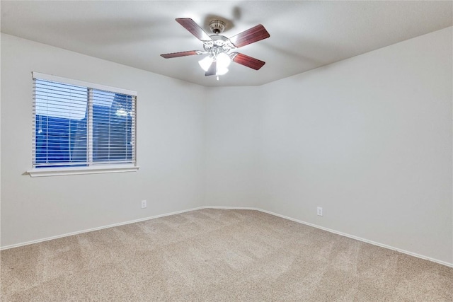spare room featuring baseboards, carpet, and ceiling fan