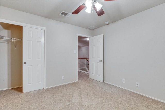 unfurnished bedroom with visible vents, carpet, and a closet