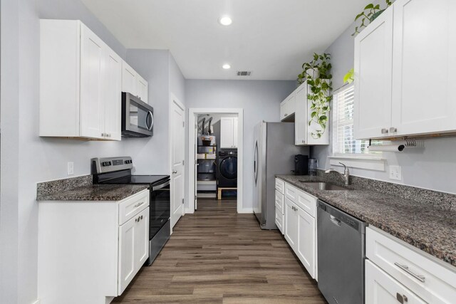kitchen with visible vents, recessed lighting, white cabinetry, a sink, and appliances with stainless steel finishes