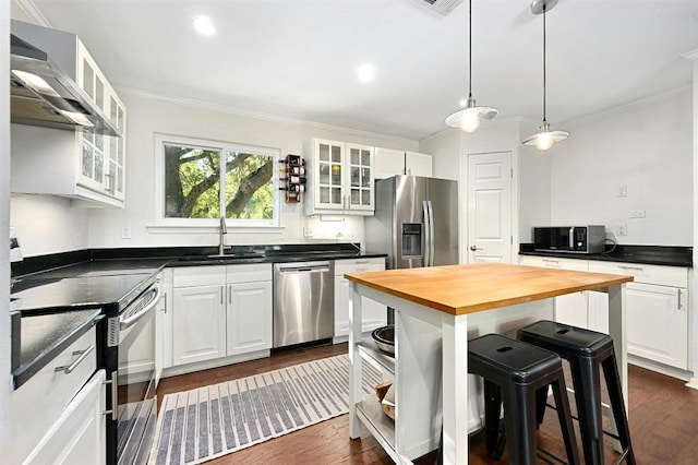 12218 Grimsley Dr, Austin, TX 78759 - kitchen with wall chimney range hood, a sink, butcher block counters, ornamental molding, and stainless steel appliances