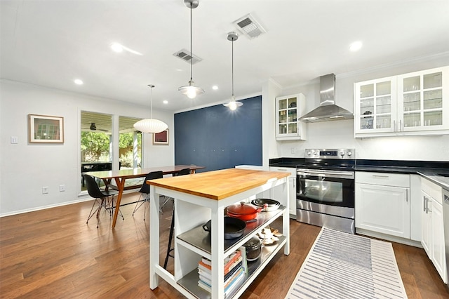 12218 Grimsley Dr, Austin, TX 78759 - kitchen featuring wooden counters, visible vents, appliances with stainless steel finishes, ornamental molding, and wall chimney exhaust hood