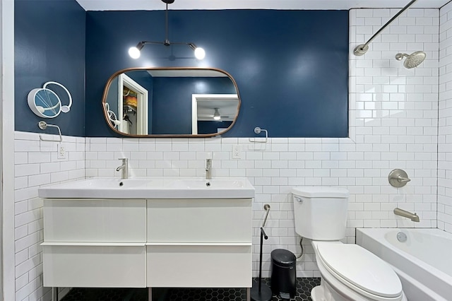 12218 Grimsley Dr, Austin, TX 78759 - bathroom featuring vanity, washtub / shower combination, toilet, and tile walls