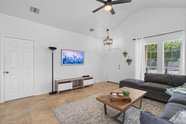 living room with high vaulted ceiling, a ceiling fan, stone finish flooring, and visible vents