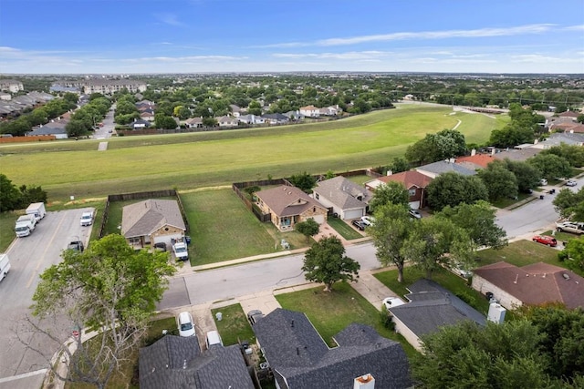 drone / aerial view with view of golf course and a residential view