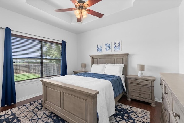 1307 Tamarac Trl, Leander, TX 78641 - bedroom with a tray ceiling, dark wood-type flooring, and ceiling fan
