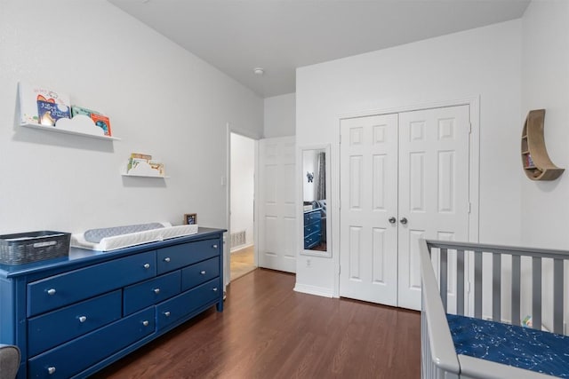 bedroom featuring a closet and dark wood-style flooring