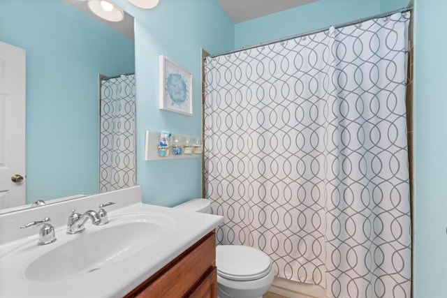 bathroom with vanity, a shower with shower curtain, and toilet