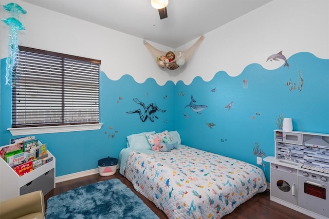 bedroom featuring a ceiling fan, baseboards, and wood finished floors