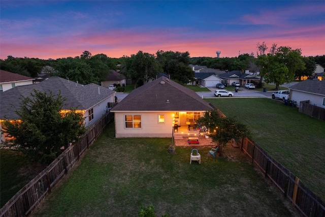 exterior space featuring a fenced backyard, a yard, and a residential view