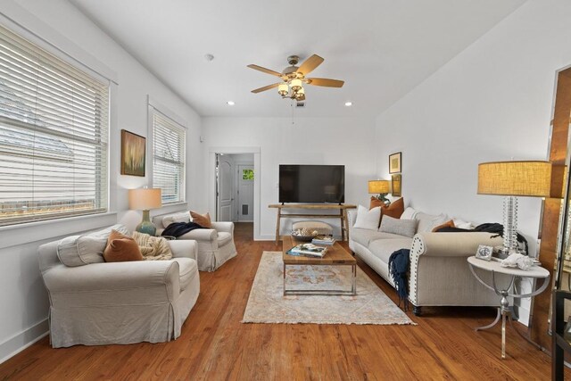 living room featuring baseboards, ceiling fan, recessed lighting, and wood finished floors