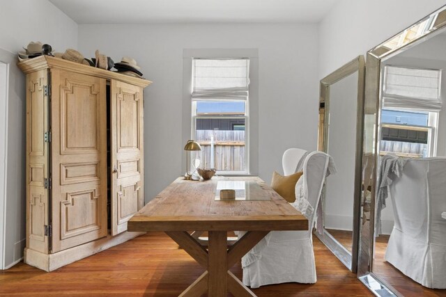 dining area featuring baseboards and wood finished floors
