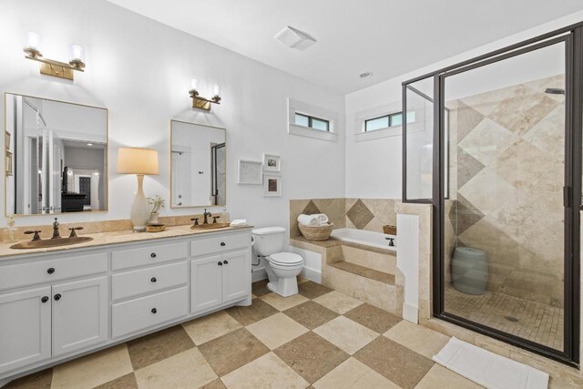 bathroom featuring a sink, a garden tub, and a stall shower