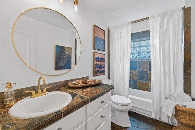 bathroom with toilet, shower / bathtub combination with curtain, stone finish floor, and vanity