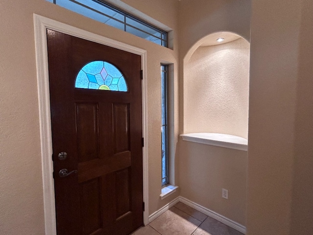 1005 Fort Davis St, Georgetown, TX 78633 - entryway featuring light tile patterned floors, baseboards, and a textured wall