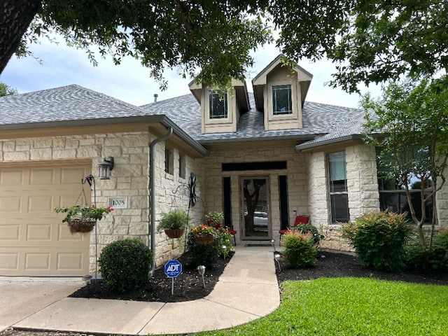1005 Fort Davis St, Georgetown, TX 78633 - view of front of property with stone siding, a garage, roof with shingles, and a front lawn