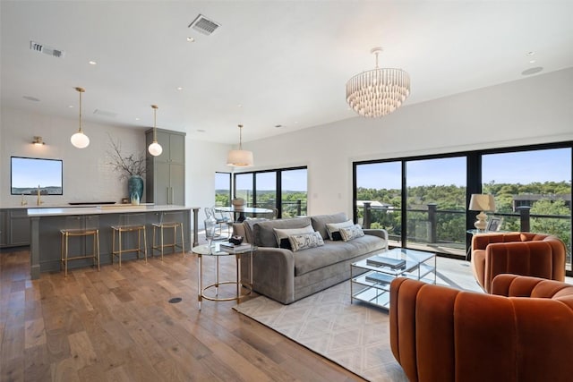5914 Cape Coral Dr, Austin, TX 78746 - living room featuring light wood-style flooring, plenty of natural light, a chandelier, and recessed lighting