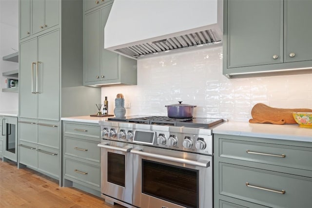 5914 Cape Coral Dr, Austin, TX 78746 - kitchen featuring range with two ovens, premium range hood, light countertops, and backsplash