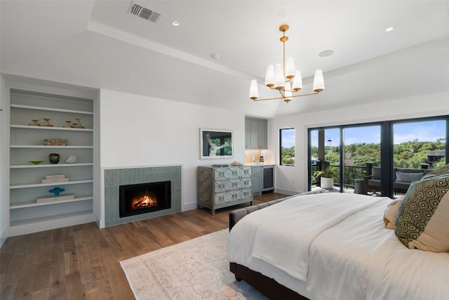 5914 Cape Coral Dr, Austin, TX 78746 - bedroom with a chandelier, wood finished floors, a tiled fireplace, baseboards, and a tray ceiling