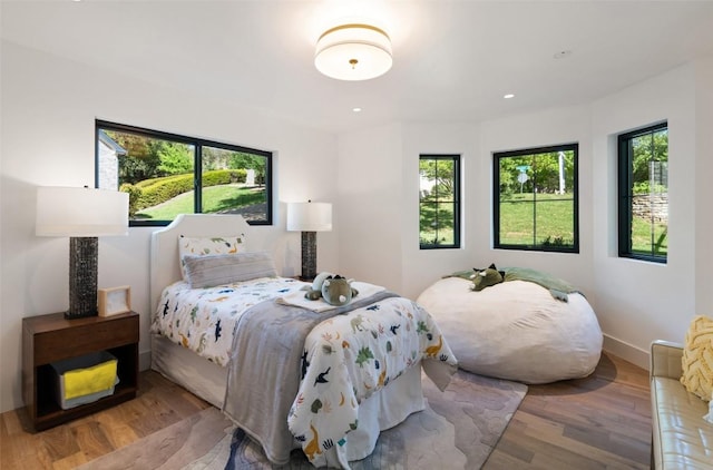 5914 Cape Coral Dr, Austin, TX 78746 - bedroom with multiple windows, wood finished floors, and recessed lighting