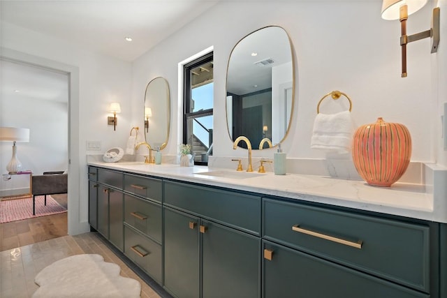 5914 Cape Coral Dr, Austin, TX 78746 - full bathroom with double vanity and wood finished floors