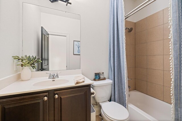 full bath with vanity, shower / tub combo, and toilet