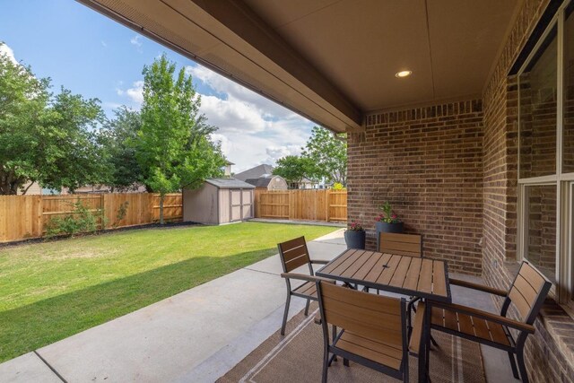 view of patio / terrace with a fenced backyard, outdoor dining space, an outbuilding, and a shed