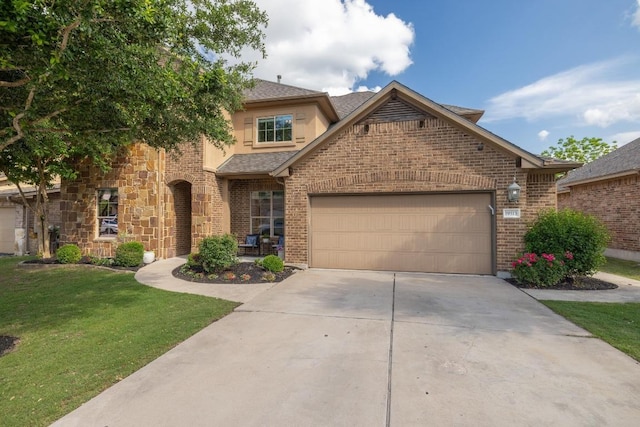 traditional-style house featuring a front yard, brick siding, a shingled roof, concrete driveway, and an attached garage