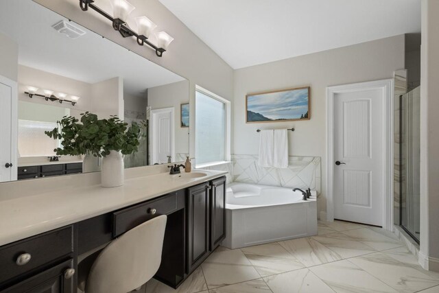 full bathroom with a garden tub, marble finish floor, vanity, and a shower stall