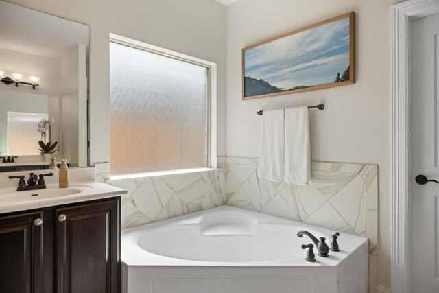full bath with vanity and a garden tub