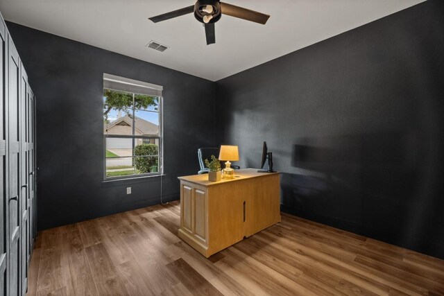 office space with ceiling fan, visible vents, and light wood-style flooring