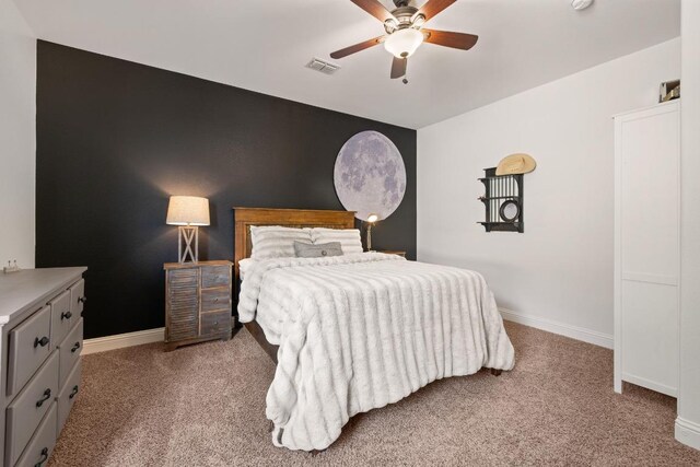 bedroom featuring visible vents, carpet flooring, baseboards, and ceiling fan