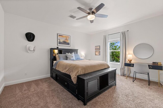 bedroom featuring baseboards, ceiling fan, light carpet, and visible vents
