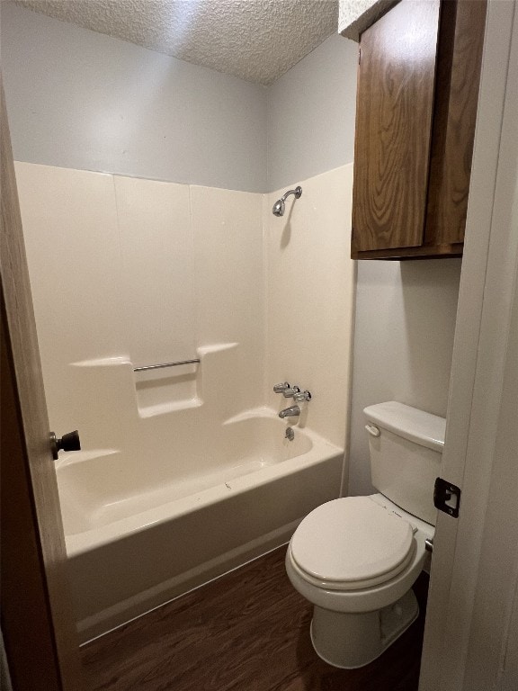 8105 Dowling Cv, Austin, TX 78745 - bathroom with a textured ceiling, shower / bathtub combination, and wood finished floors