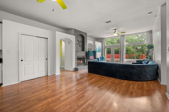 living room featuring ceiling fan, french doors, wood finished floors, and visible vents