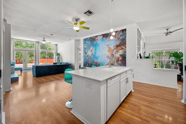 kitchen featuring french doors, a ceiling fan, open floor plan, and dishwasher