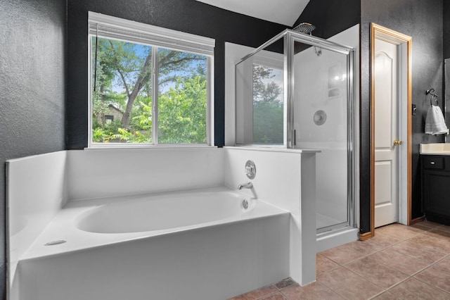 full bathroom featuring a bath, tile patterned flooring, a stall shower, vanity, and a textured wall