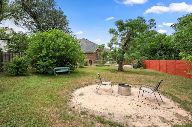 view of yard featuring a fenced backyard and an outdoor fire pit