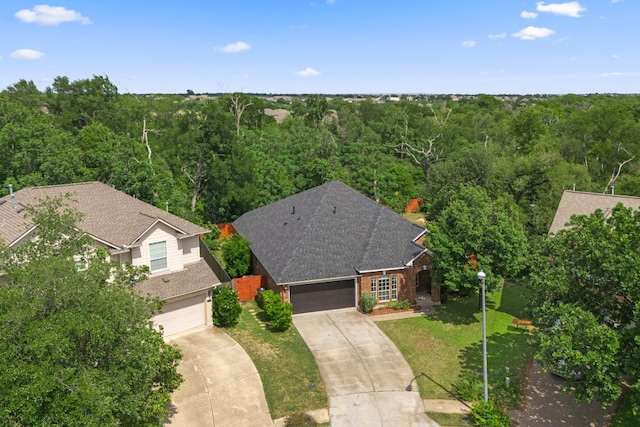 birds eye view of property with a forest view