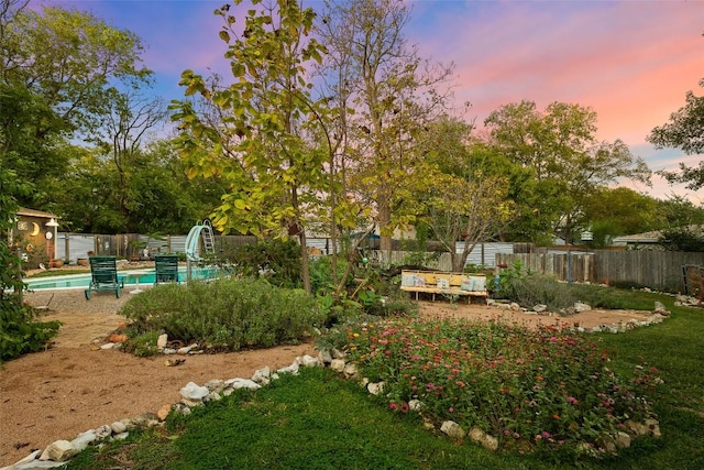 view of yard featuring a fenced in pool and a fenced backyard