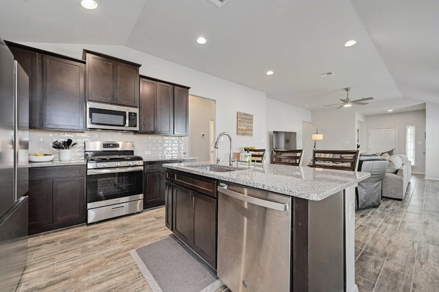 155 Lyndon Dr, San Marcos, TX 78666 - kitchen with a ceiling fan, vaulted ceiling, a sink, stainless steel appliances, and light wood-style flooring