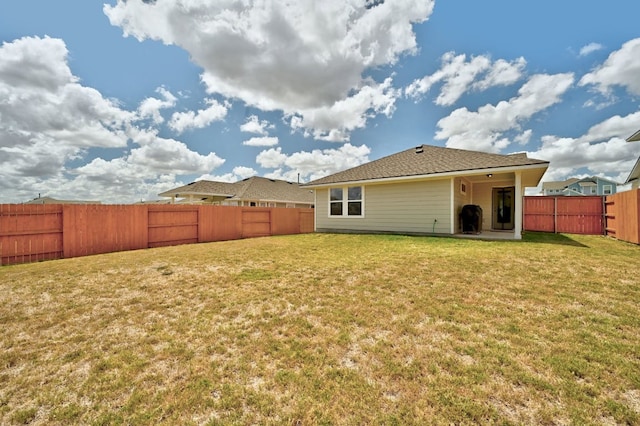 155 Lyndon Dr, San Marcos, TX 78666 - rear view of house with a lawn and a fenced backyard
